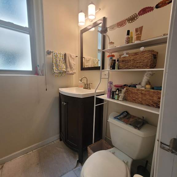 a bathroom with a white toilet and a sink.