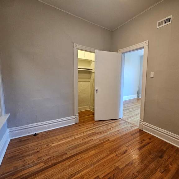 a room with a wooden floor and a white door.
