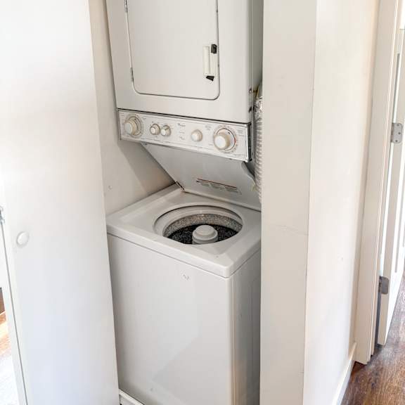 a white oven with a door open is in a room.