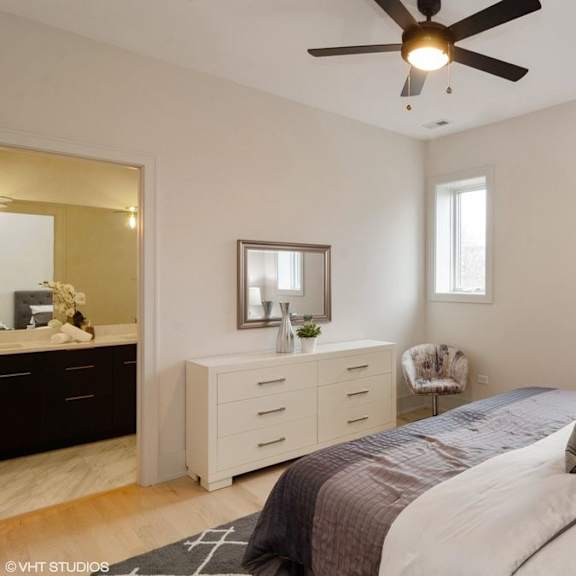 a bedroom with a bed, dresser, and mirror.