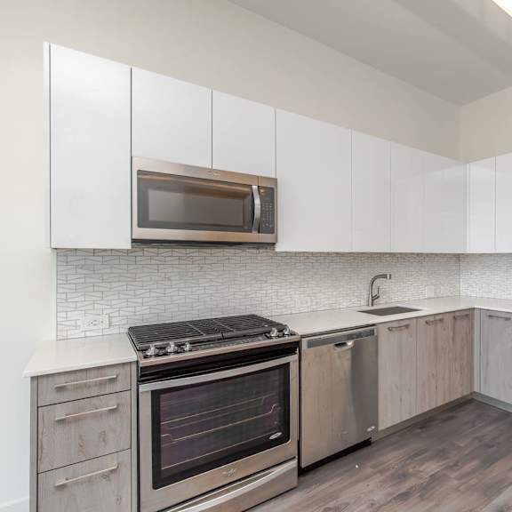 a kitchen with stainless steel appliances and white cabinets