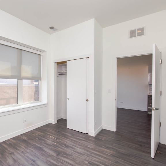 a living room with white walls and a window
