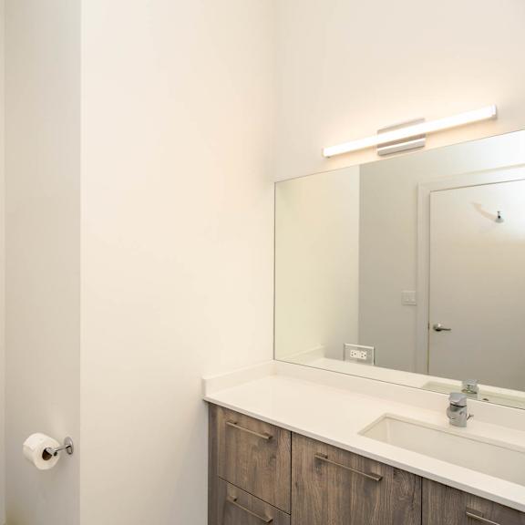 a bathroom with a toilet and a sink and a mirror