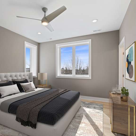 a bedroom with a large bed and a ceiling fan.