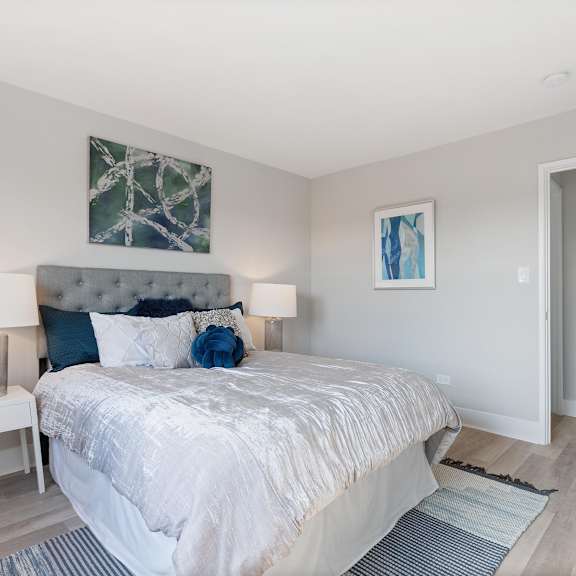 a bedroom with a bed and a door to a bathroom
