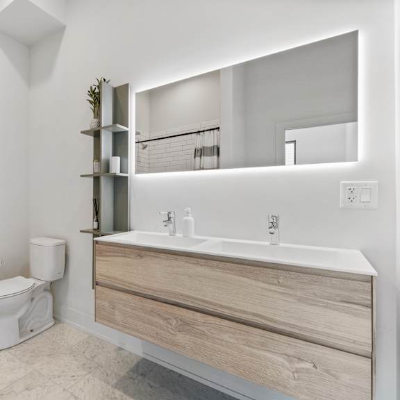 modern bathroom with a toilet sink and led mirror