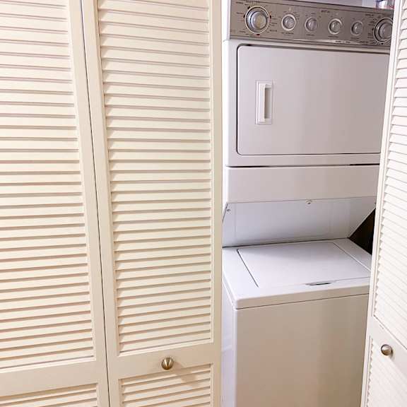 the laundry room has a washer and dryer and plenty of closet space