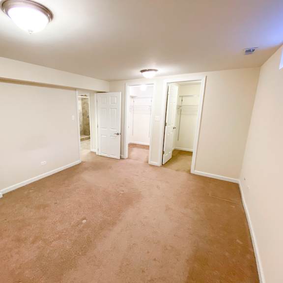 an empty room with a carpeted floor and white walls