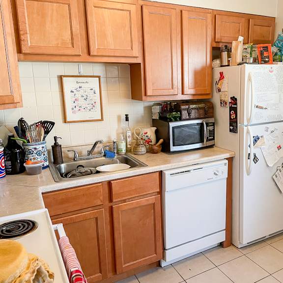 a kitchen with wooden cabinets and a white refrigerator.