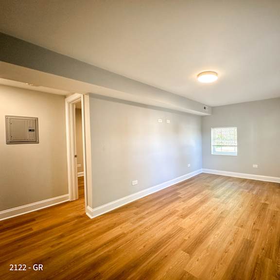 a room with wooden floors and white walls.