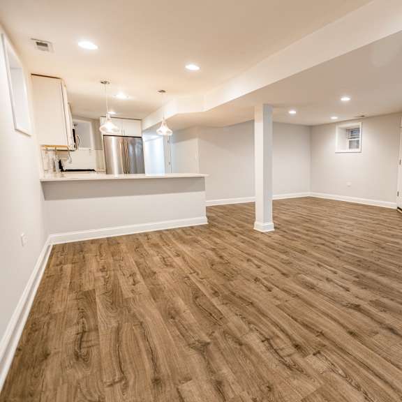 a room with wooden flooring and white walls.