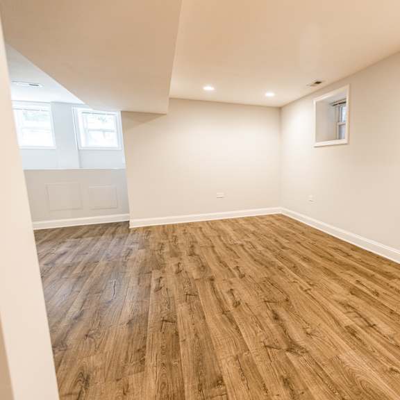 a room with wooden flooring and a window.