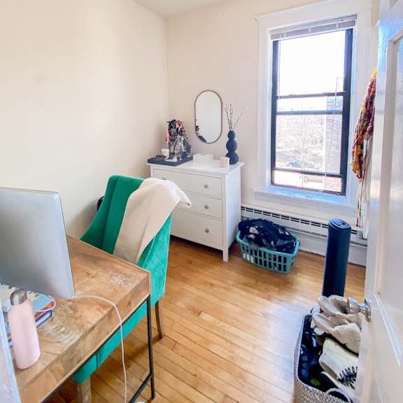 a room with a chair, a table, and a window.