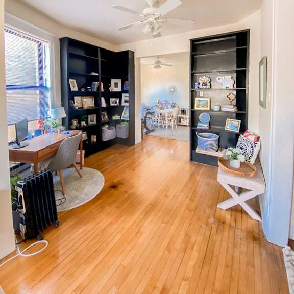 a room with a wooden floor and a ceiling fan.