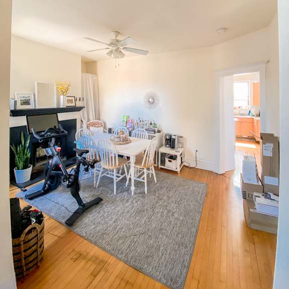 a living room with a grey rug and a white table.