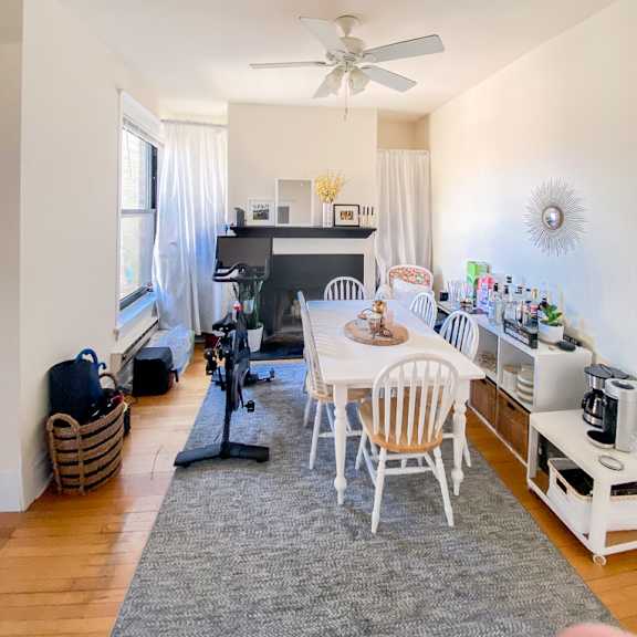 a dining room with a white table and chairs.