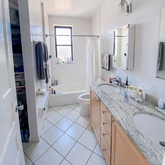 a bathroom with a toilet, sink, and bathtub.