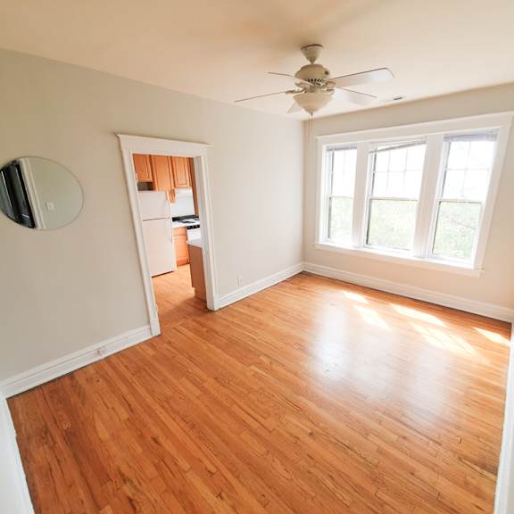 a room with a ceiling fan and a window.