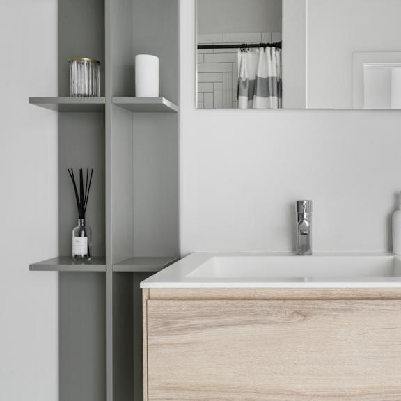 a close up of a bathroom sink with a mirror above it
