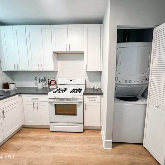 a kitchen with a white stove and white cabinets.