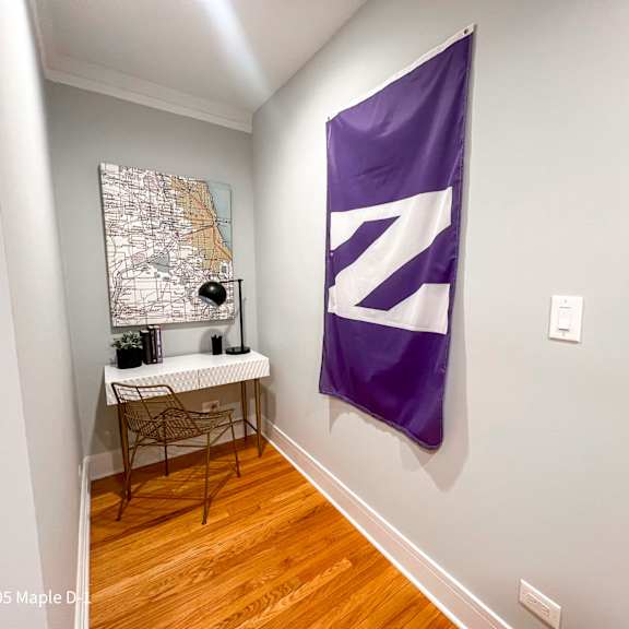 a room with a purple flag and a map on the wall.
