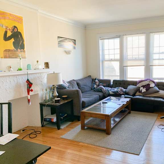 a living room with a fireplace and a couch.