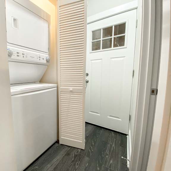 a white washer and dryer in a small laundry room.