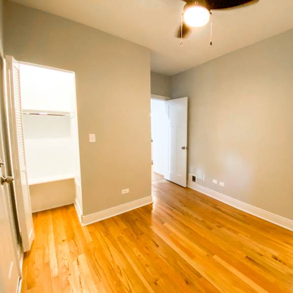 a room with wooden floors and white walls.