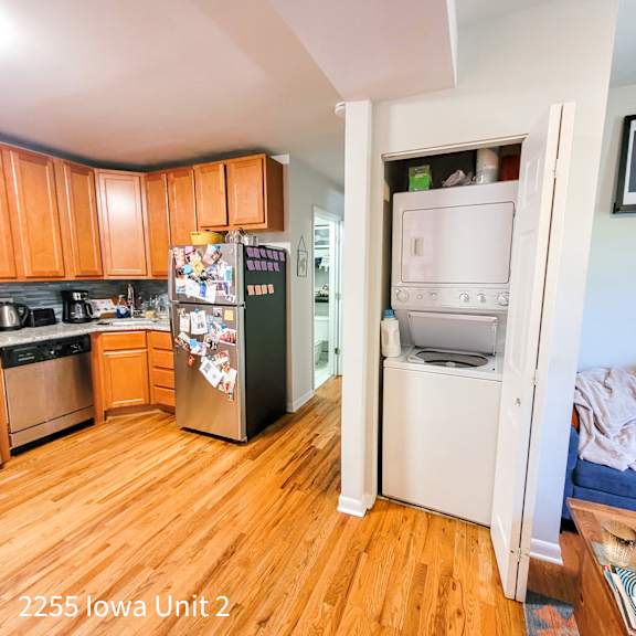 a kitchen with a refrigerator covered in magnets and a white oven in a small room.