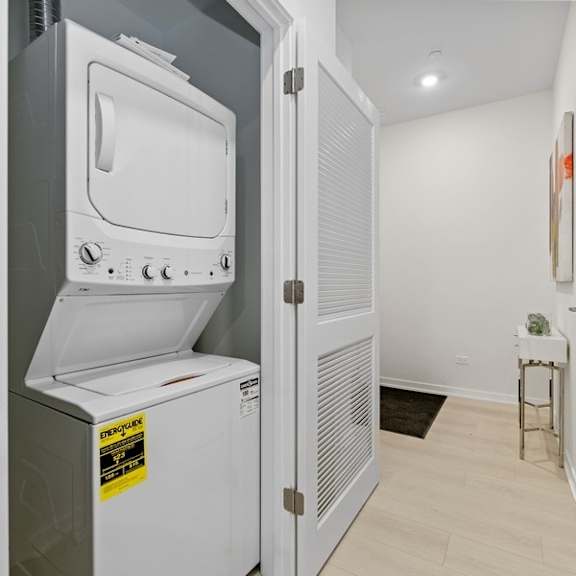the laundry room has a washer and dryer and a door to the kitchen