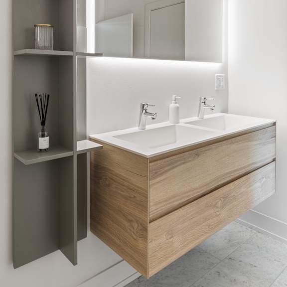 a bathroom with white walls and a wooden vanity with two sinks and a mirror
