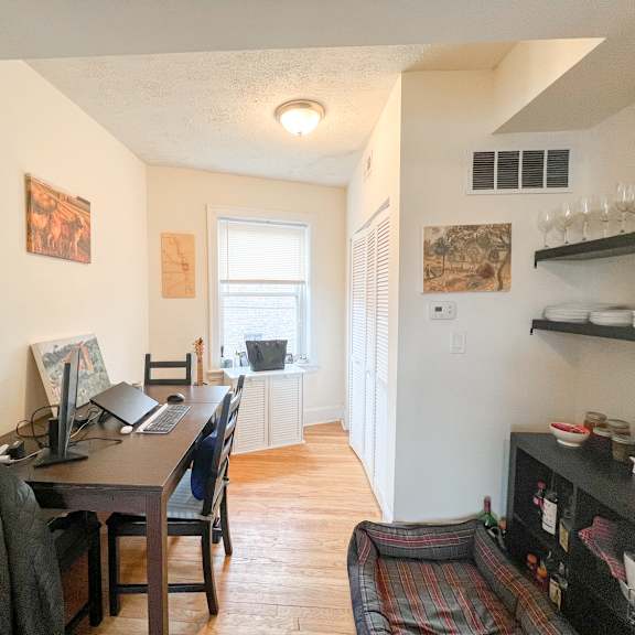 a room with a desk and a chair in it.