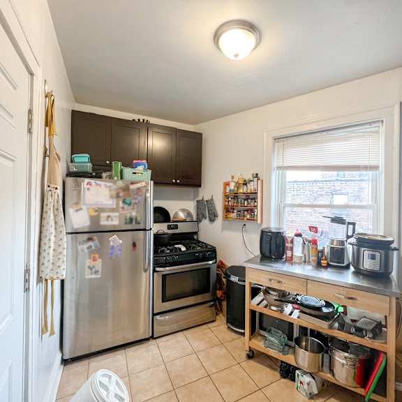 a kitchen with a refrigerator, oven, and microwave.