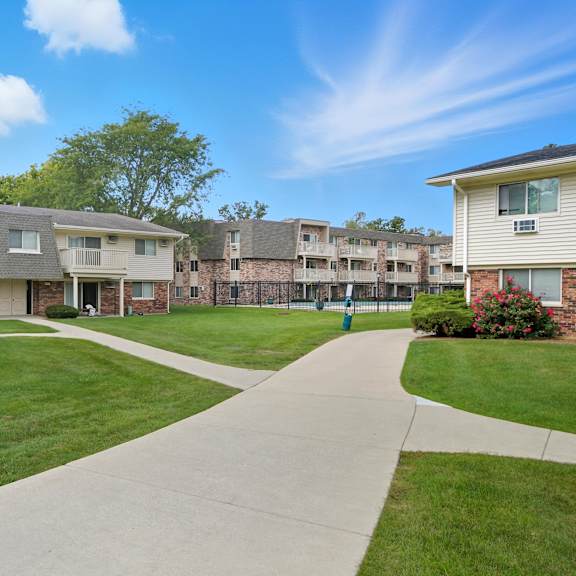 a sunny day at a residential complex with a clear blue sky.