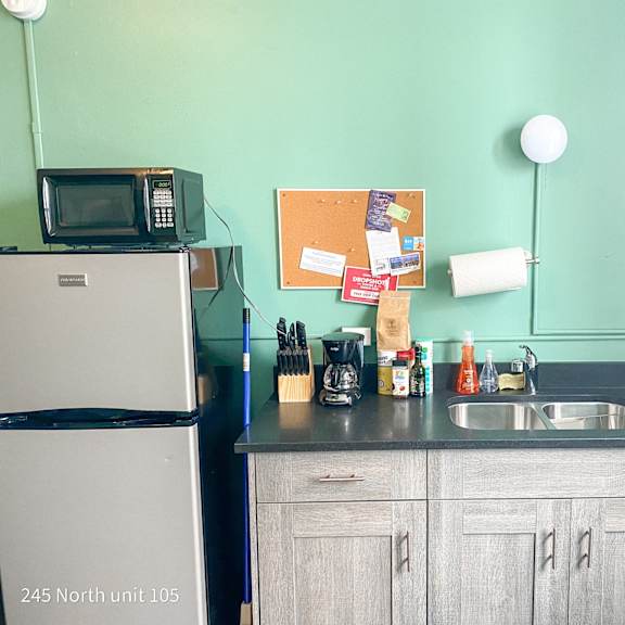 a small kitchen with a sink and a refrigerator