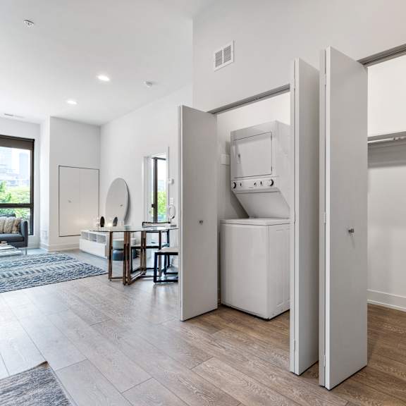 a hallway with a huge closet with a washer and dryer