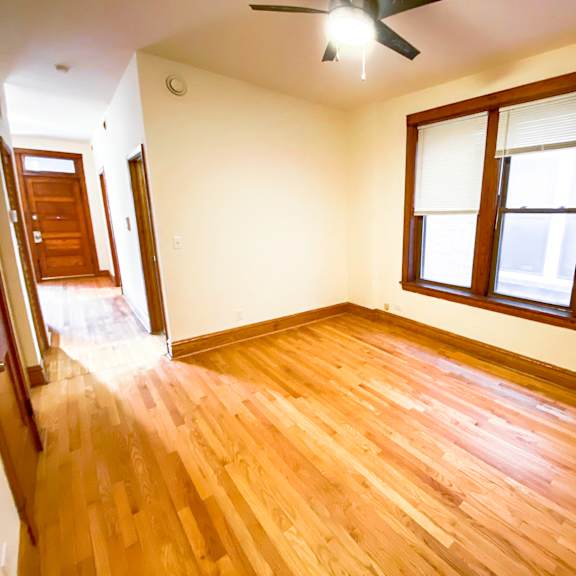 a room with wooden flooring and a window.