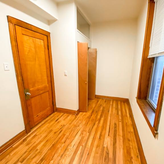 a room with a wooden floor and a wooden door.