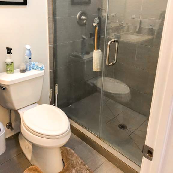 a bathroom with a toilet and a shower