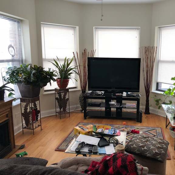 a living room with a tv in the center of it