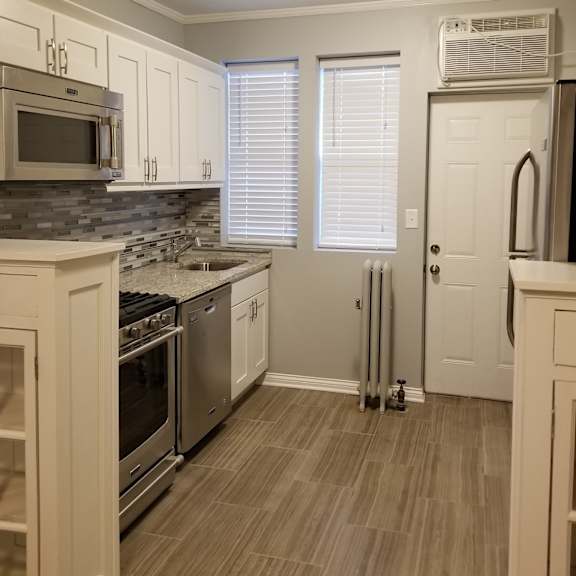 a kitchen with a stove top oven and a microwave.