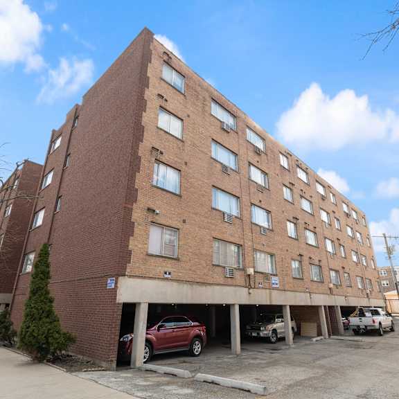 a large brick building with a parking lot in front of it