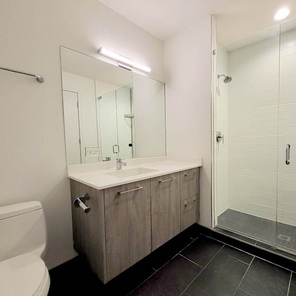 a bathroom with a toilet sink and shower