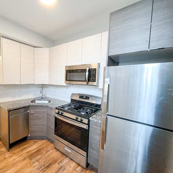 a kitchen with stainless steel appliances and a refrigerator