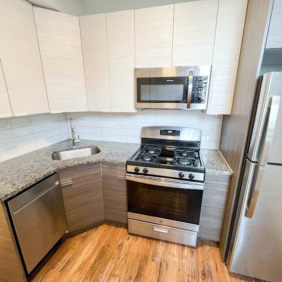 a small kitchen with stainless steel appliances and a counter top