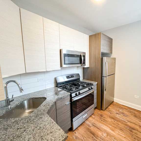 a kitchen with stainless steel appliances and a granite counter top