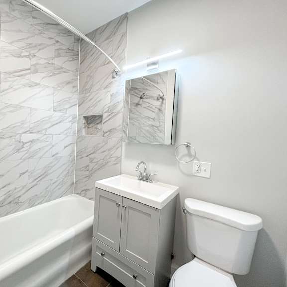 a bathroom with a sink toilet and a bath tub