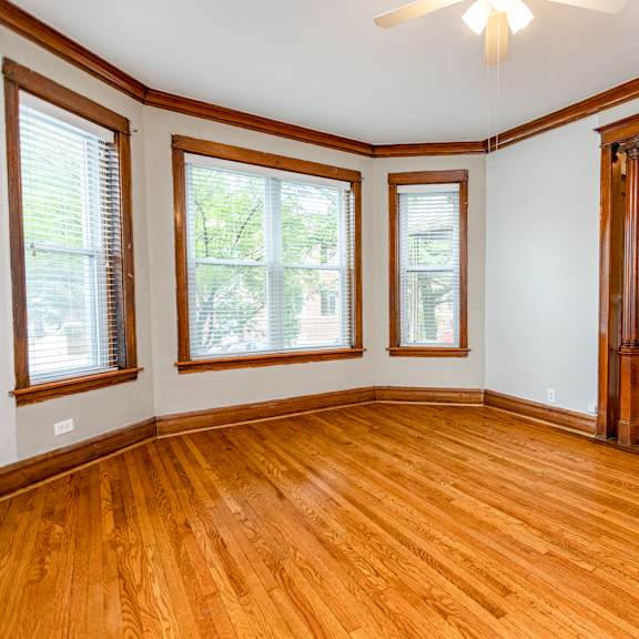 a room with wooden floors and a ceiling fan.