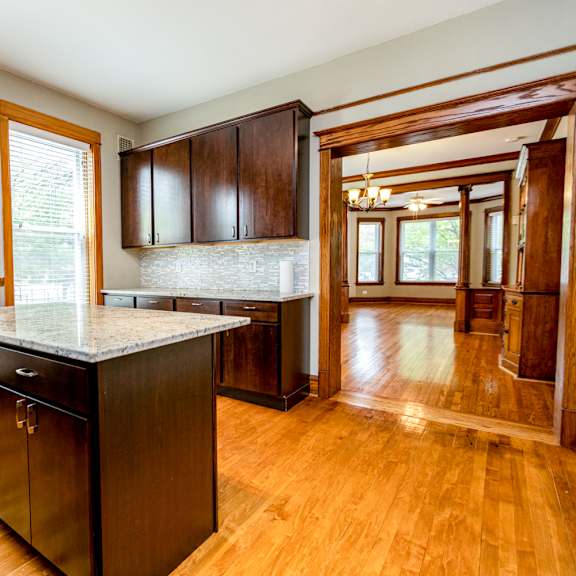a kitchen with wooden floors and a marble counter top.