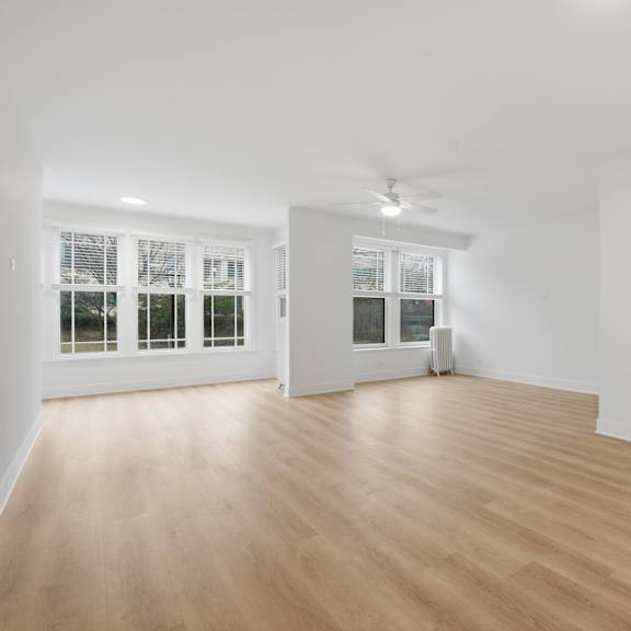 a room with wooden floors and white walls.